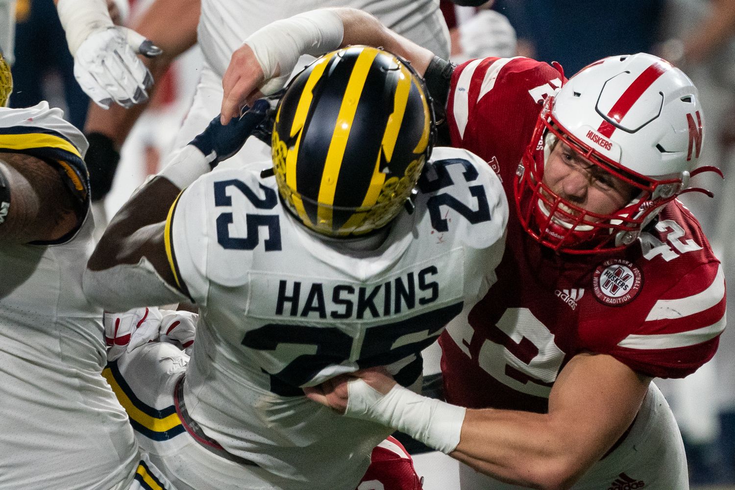 Nick Henrich tackles Hassan Haskins 2Q 2021 Michigan USATSI_16926474
